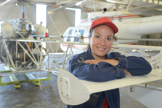 Portrait of woman in aircraft hangar