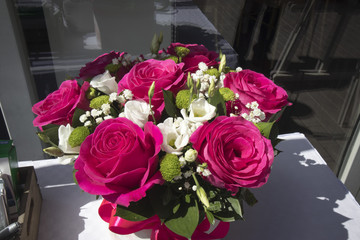Festive bouquet of red roses and gypsophilas