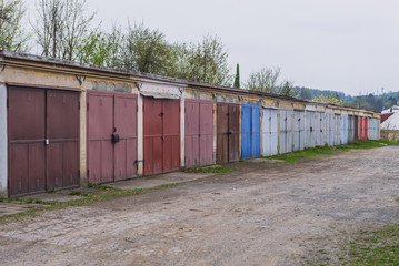 Fototapeta na wymiar Row of typical garages with metal gates in Roznov pod Radhostem, small town in Czech Republic