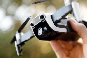 Drone quadrocopter takes off from man hand in park. Technology concept of blogger photographer.
