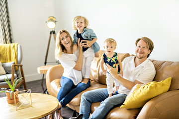 Family having fun on sofa.