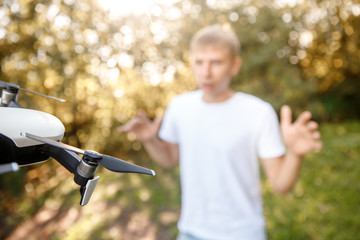 Drone fighter attacks man in park. Concept loss of control over aircraft.