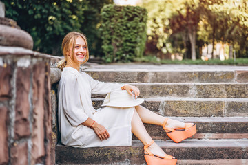 Pretty woman in white vantage dress outdoor