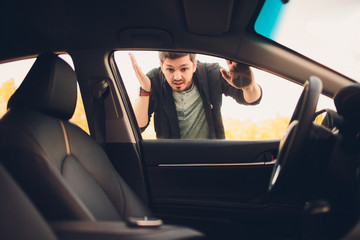 man forgot the key inside of his car.Transportation, crime and ownership concept