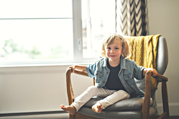 Cute two years old child sit on chair