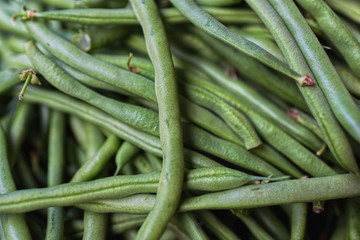 Fresh green string bean in the market for cooking. Long beans or french beans. Food background.