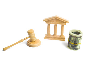 wooden government building Judge's hammer and money, on a white background. concept of state administration and economic institutions. Municipality, government, elections. Reforms, sanctions. Bank