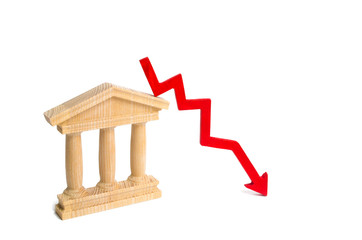 State building and a red arrow down. The concept of the fall in the efficiency of the state, the...