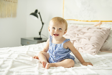 Fototapeta premium Cute baby girl on bed at home