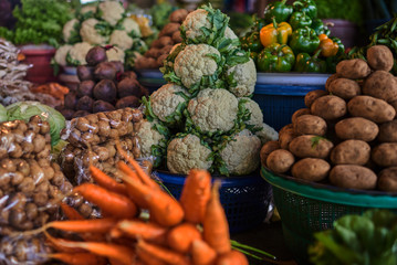 Assortment fresh organic vegetables. Country style market. Concept local farmer produce. Fruits and vegetables at a farmers market. Eco food. Baskets full of locally grown vegetables at local market.
