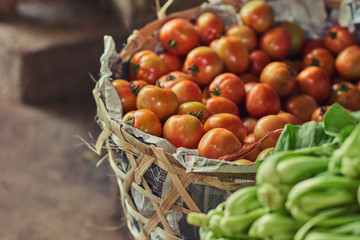 Fresh tomatoes from farm in a basket. Fresh organic produce on sale at the local farmers market. Selective focus.