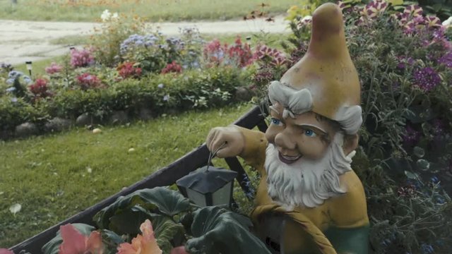 Slow motion shot of garden decorations including dwarf