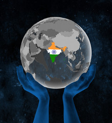 India on globe in hands in space