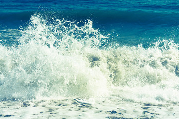Fototapeta na wymiar Vintage style image of waves crashing in the deep blue Mediterranean sea