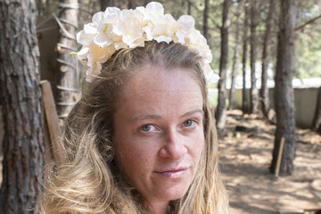 woman with flower wreath in forest