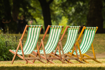 London, UK - July 8th, 2018 - deckchairs stand in a row on the grass