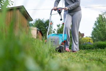 outdoor worker mowing the lawn