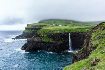 The small village Gásadalur with its iconic cliffs and the waterfall