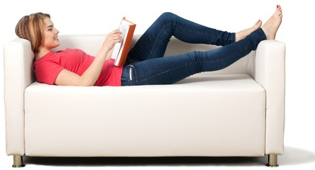 Woman reading book on sofa isolated on white background - Powered by Adobe