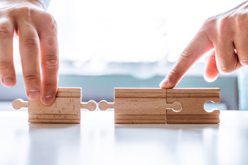 The man points to the same two incompatible jigsaw puzzles. The concept of misunderstanding,...