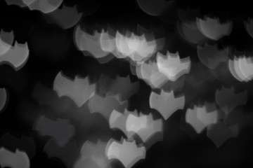 holidays, decoration and party concept - defocused white bats silhouette ghosts on black for halloween background