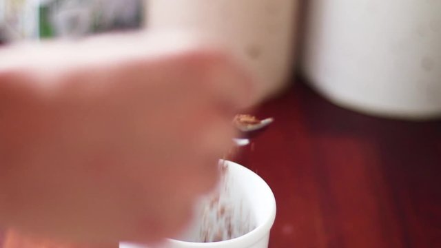 here ypu can see coffee being poured into a cup with a cozy background to make it more personal.