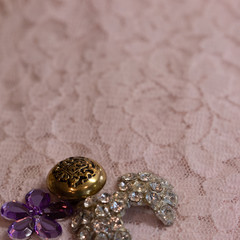 Peach lace and vintage buttons background