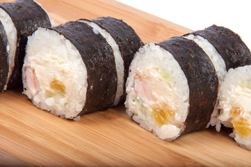 tasty sushi roll on the wooden board background