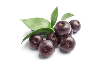 Fresh acai berries with leaves on white background