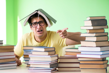 Student with too many books to read before exam