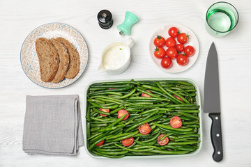Flat lay composition with tasty green beans on table