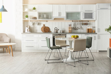Stylish kitchen interior with dining table and chairs