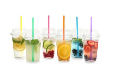 Plastic cups with lemonades on white background