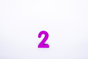 Pink digit 2 isolated on a white background. Wooden number 2 on a white background.