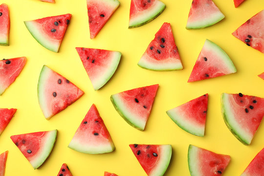 Flat lay composition with slices of watermelon on color background