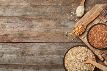 Fototapeta na wymiar Flat lay composition with different types of grains and cereals on wooden background