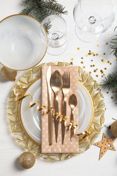 Elegant table setting on light background, top view. Christmas celebration