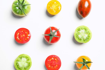 Flat lay composition with different tasty tomatoes on white background
