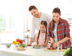 Obraz na płótnie Canvas Happy family preparing breakfast together in kitchen