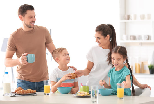 Happy family having breakfast together in kitchen