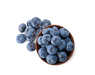 Bowl full of fresh ripe blueberries on white background, top view