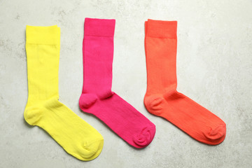 Flat lay composition with different colorful socks on gray background