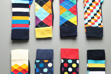 Flat lay composition with different colorful socks on gray background