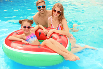 Happy family in pool on sunny day