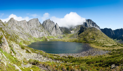 Naklejka premium Mountains under the name Dusse Alin in Russian Far East Khabarovsk region. Beautiful Mountain Lake is called the Bear in the mountains Dusse Alin.