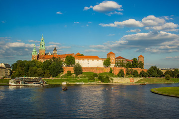 Naklejka na ściany i meble beautiful medieval european castle near river waterfront old city district and space for walking concept shot in bright colorful contrast summer day time without people on blue sky background 