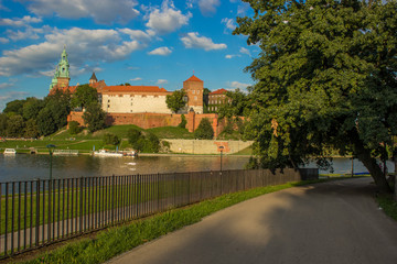 Fototapeta na wymiar beautiful medieval european castle near river waterfront old city district and space for walking concept shot in bright colorful contrast summer day time without people on blue sky background 