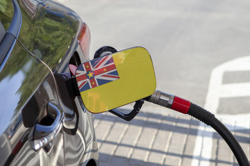 Fueling car with petrol pump at a gas station.