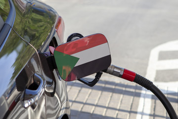 Fueling car with petrol pump at a gas station.