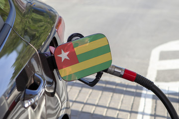 Fueling car with petrol pump at a gas station.